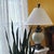 Sculptural traditional table lamp styled after Ashley Gavivi, centered by an off-white ceramic urn with finely textured...