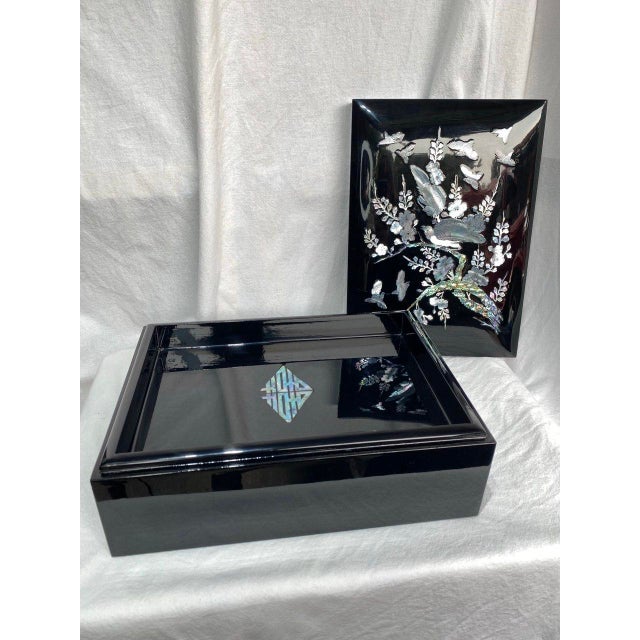 This elegant Korean lacquer document box is finished in a deep piano-black lacquer and richly inlaid with mother-of-pearl...