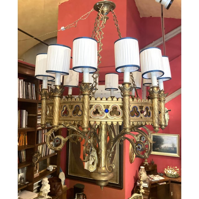 This antique 19th century Italian large gilt bronze and enameld Neo Gothic pendant chandelier dating back to 1850 circa is...