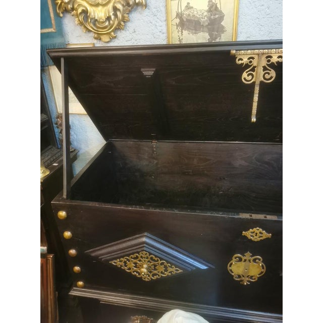 This item has been totally restored, the metal has been polished. It features a big drawer. The top opens.
