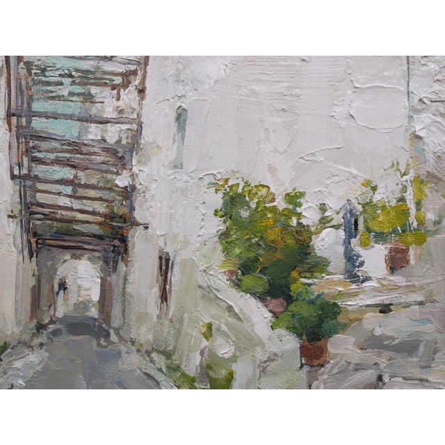 This oil on board artwork captures a serene moment in the picturesque streets of Ostuni, Italy, where whitewashed...