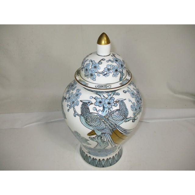 Japanese hand painted porcelain temple jar. It is decorated with phoenix birds nestled among blooming peony flowers in...