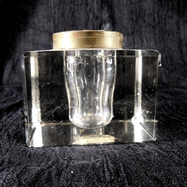 This is a large crystal inkwell that has darkened a bit. It has a brass color metal fitting and a matching lid, but the...