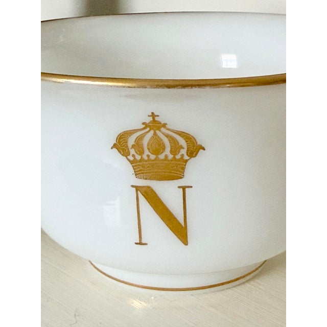 Crafted from smooth, opaque milky glass, this vessel features a printed reproduction of the iconic Napoleonic imperial...
