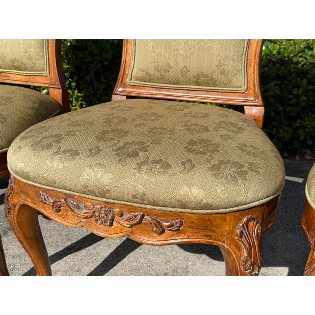 A handsome set of six Century Furniture French Provincial dining chairs featuring gracefully curved backs, carved crest...