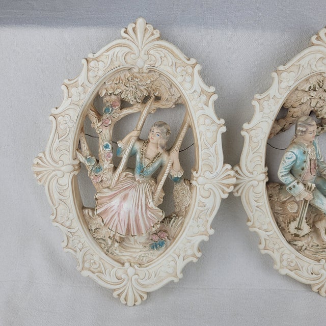 Vintage 1962 Jayess United Chicago chalkware wall plaques featuring a romantic Rococo-style couple. This pair includes a...