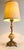 A beautiful Neoclassical gilded bronze lamp of Italian origin, circa 1920s–1950s. This lamp begins at the base, a marvel...