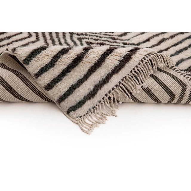 Lines that pulse, bend, and converge like an optical illusion. Dense midnight black stripes ripple across an ivory field,...