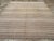 This Mid-20th century Turkish Flatweave Kilim rug, features a classic horizontal stripe design woven in soft, natural...