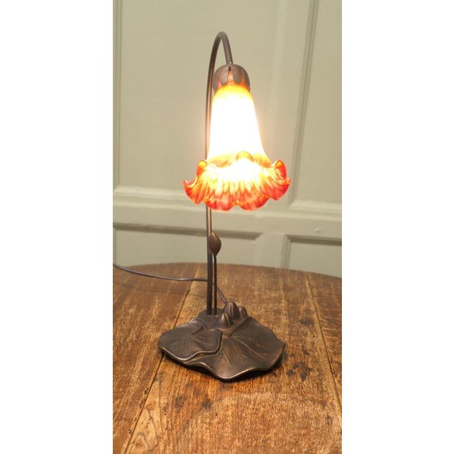 French Bronze Lilly Pad Table Lamp with Glass Shade French Bronze Lilly Pad Table Lamp with Fire Red Bell Flower Glass...