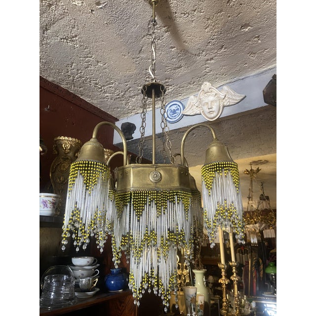 This Beautiful chandelier features four arms as you can see on the pictures and a main central body. All beads are in...