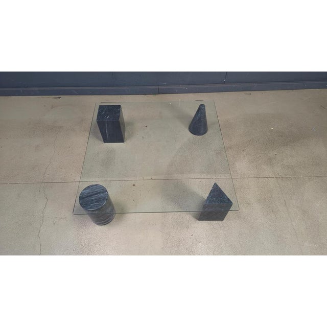 Coffee Table with a clear glass top and Geometric solid Marble Shapes in the style of ‘Metafora’ by Lella and Massimo...
