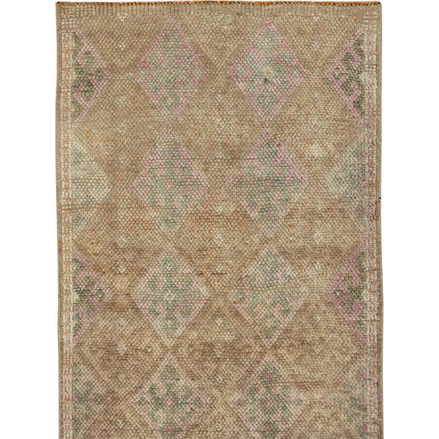 This mid-20th-century Turkish Anatolian runner presents an allover lattice of softly drawn diamond-shaped compartments...