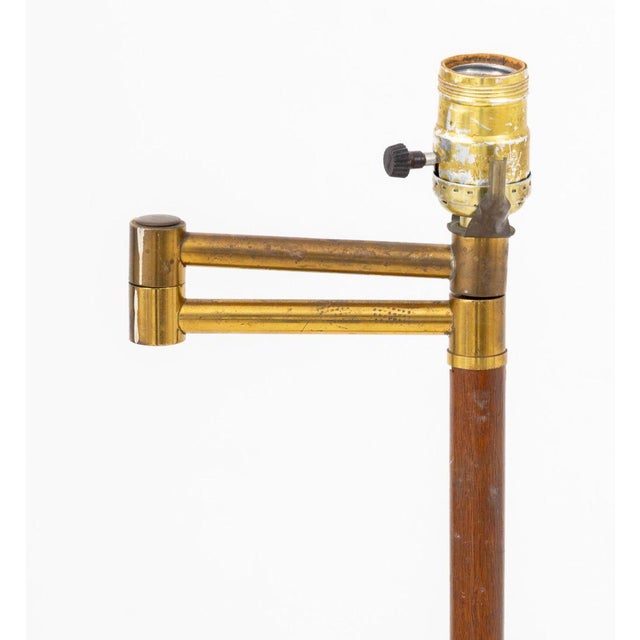 Mid-Century Modern Brass and Walnut Swing Arm Floor Lamp, terminating in trefoil brass base. 45.5" H x 15" W x 12" D....