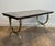 This beautiful and elegant neoclassical-style coffee table is made of bronze and brass with a black and gold marble top....