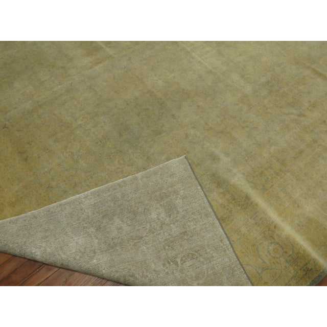An antique Persian Tabriz in pale green, blues and yellow. Measures: 10'4'' x 13'9''.