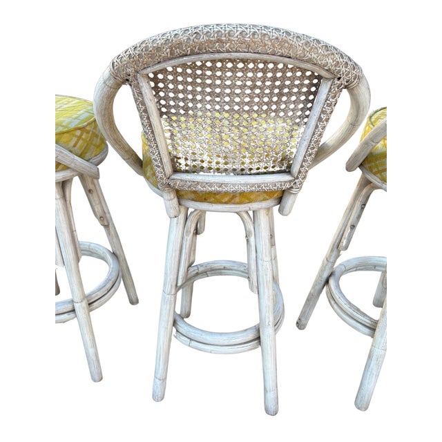 Set of three vintage rattan swivel bar stools by Kalp-Son Rattan Co., a respected California maker known for high-quality...