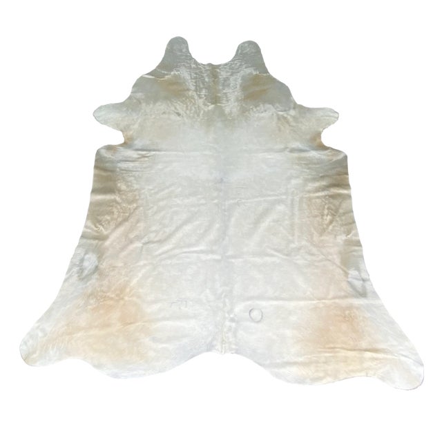 Stunning extra large Brazilian cowhide in a glossy blonde champagne color way perfect in a monochromatic setting. We hand...