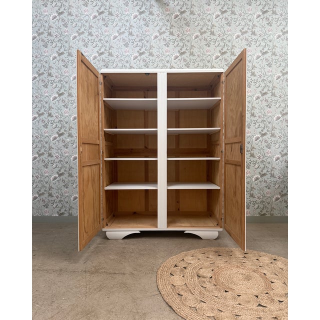 With its clean, balanced lines, this vintage 1950s art deco wardrobe captivates with its understated elegance. Its light...