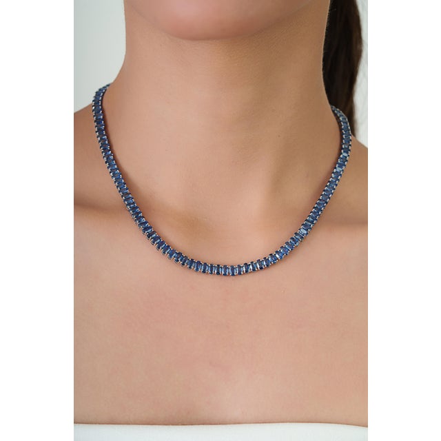 This elegant tennis necklace features 34.91 carats of blue sapphires set in 14K white gold. Each sapphire measuring...