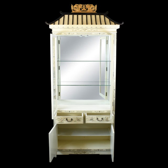 Chinoiserie Pagoda White Cabinet with Light A striking vintage Chinoiserie-style cabinet featuring an architectural pagoda...