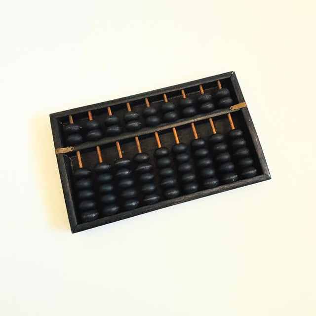 A beautiful vintage black wood abacus.