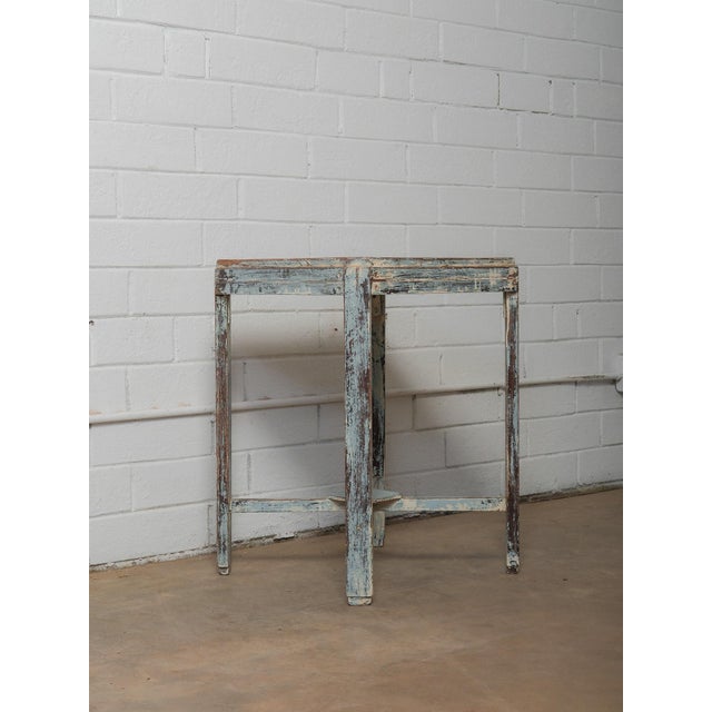 This distressed painted wooden accent table features a beautifully weathered blue finish that highlights years of natural...