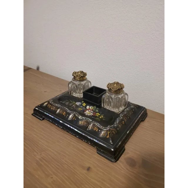 An English Victorian Japanned papier mache desk set with mother of pearl inlay and elaborate rich polychrome painted...