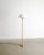 A rare Finnish mid century floor lamp in patinated brass,decorative wrapped leather with a white lacquered aluminum shade...