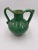 Terracotta jug with spout in handle. Green light and dark glaze, circa 1860. Once a common piece of pottery used daily in...