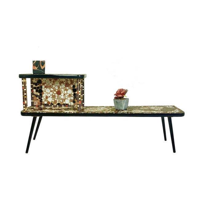 Very nice designed 1970’s two-tier side or plant table with little ceramic tiles in mosaic and tapered wooden legs. This...