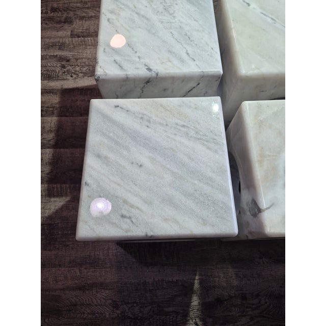 4 mint condition side tables carved from a solid block of bianco crown marble, features distinctive circle cutouts....