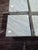 4 mint condition side tables carved from a solid block of bianco crown marble, features distinctive circle cutouts....