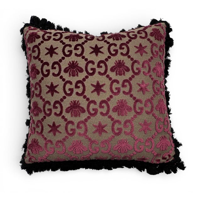 Gucci's 17-inch square pillow features GG pattern jacquard upholstery interspersed with bees and stars—codes that have...