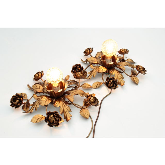 Set consisting of two wall lamps from the 1970s in Italy, in a floral style, with leaves and rose tendrils made of gilded...