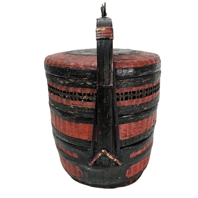 This vintage Chinese lacquered woven covered nesting basket from the early20th century with beautiful finish in red and...