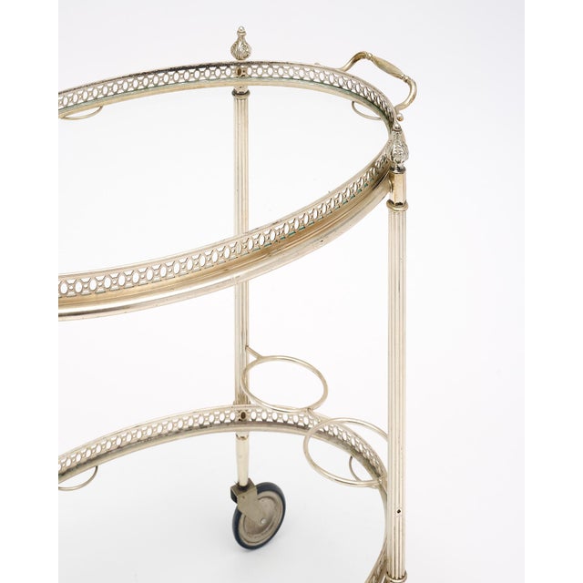 Bar cart from the Art Deco period in France. This piece has a silver-plated brass structure with open galleries on both...