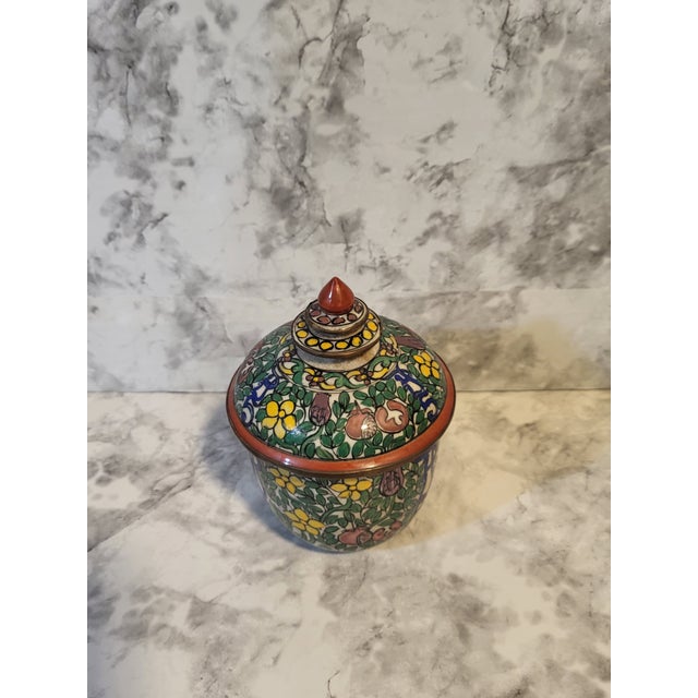 This is a Thai Benjarong porcelain covered vessel. Thai craft is known for its intricate, hand-painted designs using...