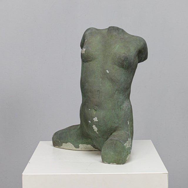 A sculptural female torso executed in concrete by dutch artist francine govers, dating to the 1990s. The surface is...