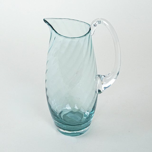 The jug was made in the 1970s in Italy. A glass jug from the 1960s/1970s, made using the hand-forming technique. The...