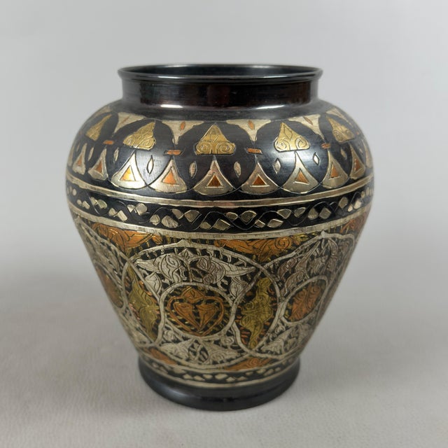 This refined piece represents an example of excellence in Asian artistic craftsmanship in hand-crafted metalwork. The vase...