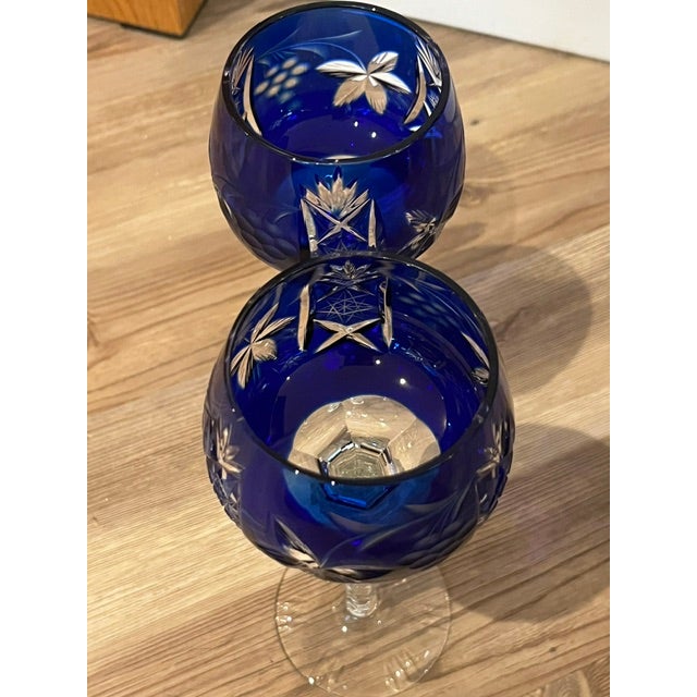 Pair of vintage Nachtmann Bohemian Traube cobalt blue cut crystal wine glasses featuring a grape pattern. Made of glass...