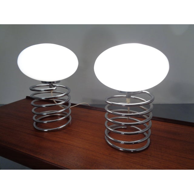 Honsel lamp by Ingo Maurer with chrome-plated spiral stand and opal glass globe from the 1970s. This piece has an...