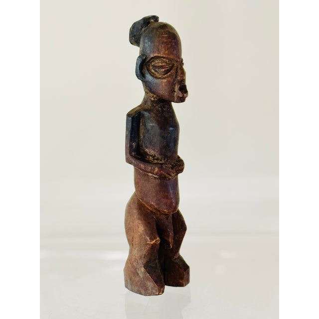 A carved wood “bateba” figure. Made by the Lobi people and placed on altars for protection against illness and misfortune....