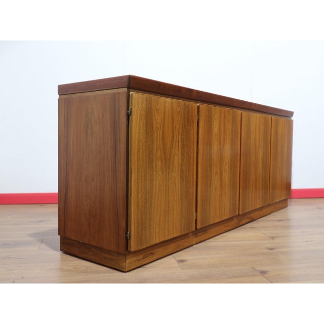 Discover the Mid Century Modern Vintage Rosewood Danish Credenza Sideboard by Skovby, a stuuning credenza that embodies...