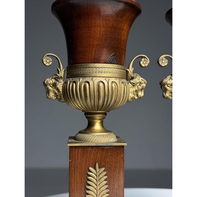 Pair of 19th-century decorative vases. Originally from France. Crafted from solid mahogany. with gilded bronze elements,...