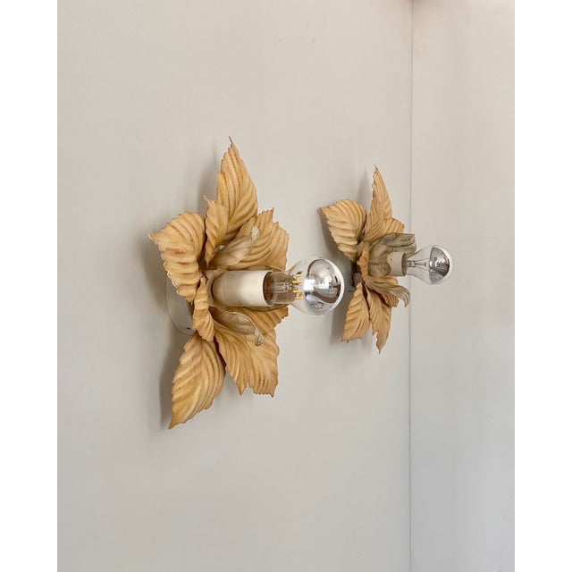 Pair of wall sconces with a beige painted metal frame, produced in France in the 1970s. Classic design inspired by a...