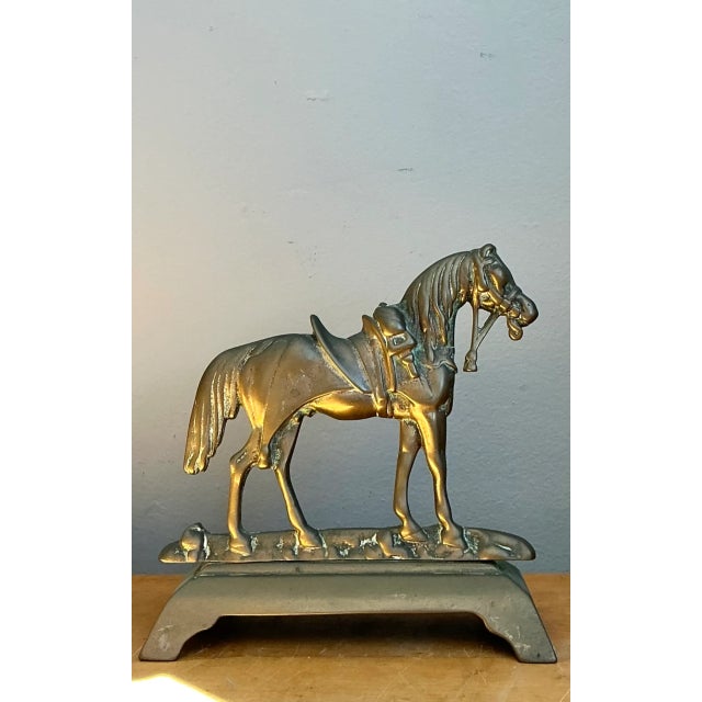 Crafted from brass, this vintage horse door stop exudes the timeless charm of mid-20th-century decorative arts. A finely...