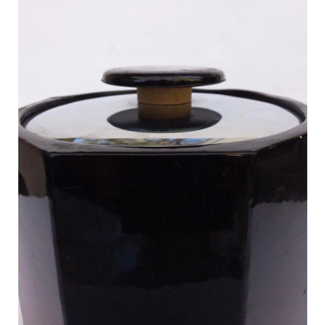Vintage ice bucket covered with a black leatherette/ vegan leather with a stainless chrome lid and chrome handle....