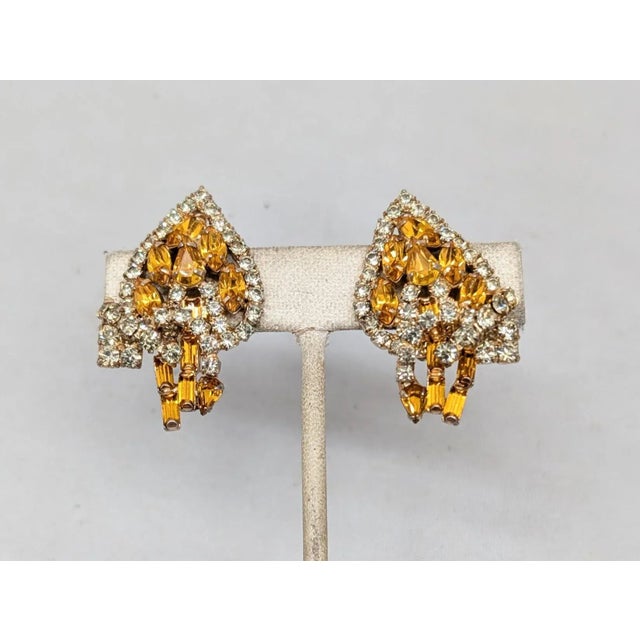 1950s goldtone prong set marquise and baguette faux-citrines with small round clear rhinestone accents leaf clip earrings....